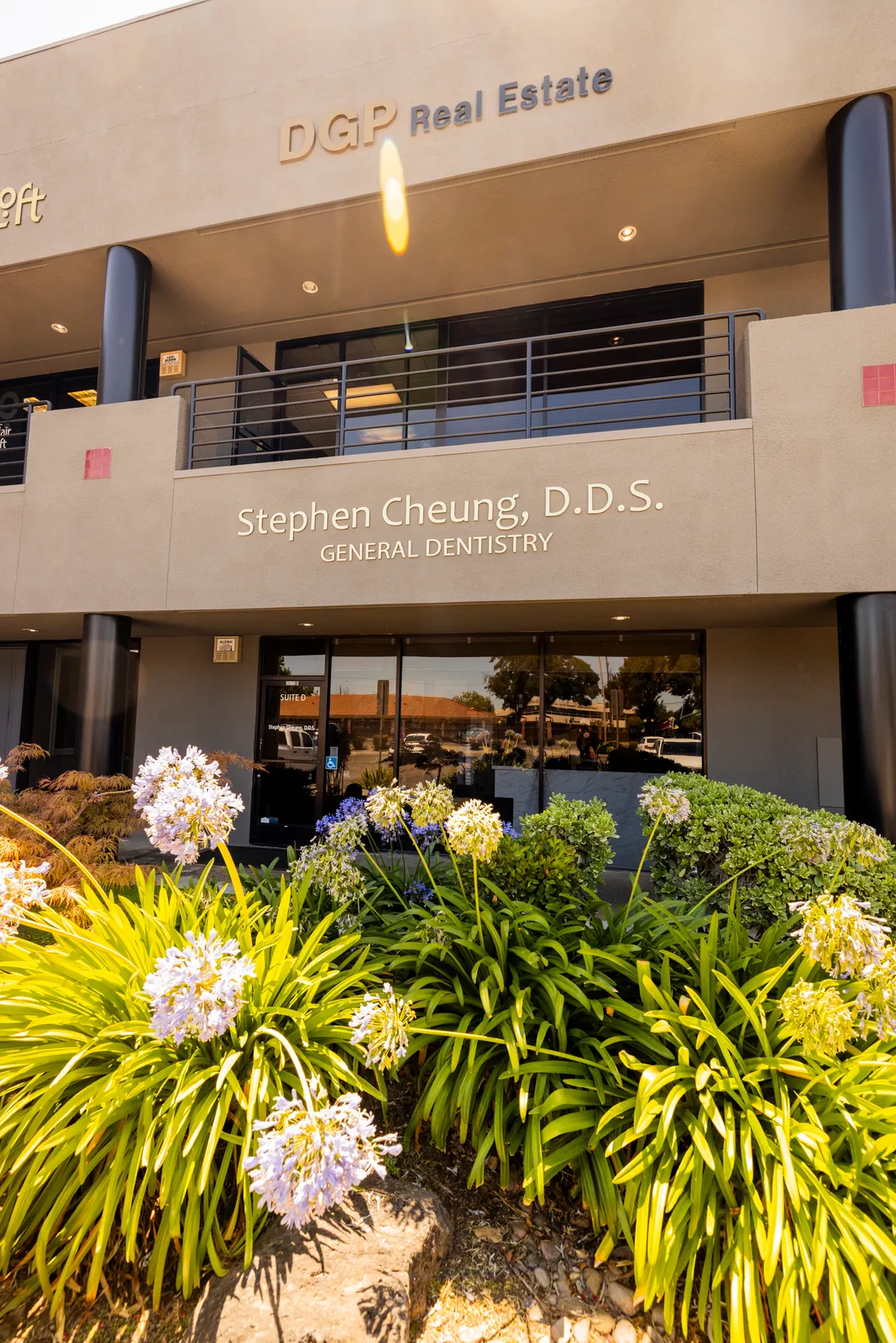 Stephen Cheung DDS office entrance framed by a flowering garden